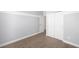 Empty bedroom with laminate flooring, neutral paint, and built-in closet space at 2028 Ulster St, Denver, CO 80238