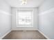 Bedroom with large window and wood-look floors at 2028 Ulster St, Denver, CO 80238