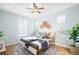 Stylishly decorated bedroom featuring a ceiling fan, modern decor, and an inviting queen-size bed at 2028 Ulster St, Denver, CO 80238