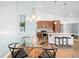 Open dining area featuring a modern glass table and pendant lighting at 2028 Ulster St, Denver, CO 80238