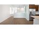 Open concept dining area with light walls and vinyl plank flooring at 2028 Ulster St, Denver, CO 80238