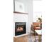 Close-up of a modern fireplace with a tiled surround and a decorative mantel, adding warmth and elegance to the room at 2028 Ulster St, Denver, CO 80238