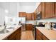 Spacious kitchen featuring stainless steel appliances, wood cabinets, and ample counter space at 2028 Ulster St, Denver, CO 80238