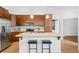 Spacious kitchen with a large island, stainless steel appliances, and wood cabinetry at 2028 Ulster St, Denver, CO 80238