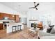 Open-concept living room and kitchen featuring modern appliances, a cozy fireplace, and stylish furnishings at 2028 Ulster St, Denver, CO 80238