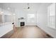 Bright living room featuring a corner fireplace and vinyl plank flooring at 2028 Ulster St, Denver, CO 80238