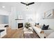 Inviting living room featuring a fireplace, modern furnishings, and a ceiling fan, perfect for relaxation and gatherings at 2028 Ulster St, Denver, CO 80238