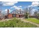Two-story brick home with a backyard, green lawn, and established landscaping at 12807 Garfield Cir, Thornton, CO 80241