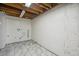 Unfinished basement area featuring tile flooring and exposed ceiling, ready for customization at 12807 Garfield Cir, Thornton, CO 80241