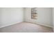 An empty bedroom is naturally lit by a window with neutral carpet and white walls at 12807 Garfield Cir, Thornton, CO 80241