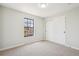 Bright bedroom with a big window, neutral carpet, and sliding closet doors at 12807 Garfield Cir, Thornton, CO 80241