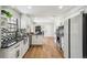 Modern kitchen with white cabinetry, black countertops, and stainless appliances at 12807 Garfield Cir, Thornton, CO 80241