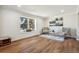 Elegant living room featuring hardwood floors, ample natural light, and stylish decor at 12807 Garfield Cir, Thornton, CO 80241