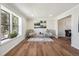 Bright living room featuring hardwood floors, large window, and modern decor at 12807 Garfield Cir, Thornton, CO 80241