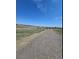 Scenic walking path near the home with views of open fields and a distant pond at 12807 Garfield Cir, Thornton, CO 80241