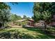 Large backyard with grassy area and mature trees surrounding home at 3792 E Briarwood Ave, Centennial, CO 80122