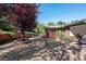 Spacious backyard with gravel area, mature tree, and patio seating at 3792 E Briarwood Ave, Centennial, CO 80122