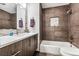 Contemporary bathroom with a soaking tub, double vanity, and modern finishes at 3792 E Briarwood Ave, Centennial, CO 80122
