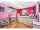 Charming bedroom with pink walls, a trundle bed, and plenty of storage at 3792 E Briarwood Ave, Centennial, CO 80122