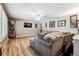Spacious living room with hardwood floors, sectional sofa and large windows at 3792 E Briarwood Ave, Centennial, CO 80122