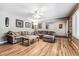 Bright living room with hardwood floors, sectional sofa, and large windows at 3792 E Briarwood Ave, Centennial, CO 80122