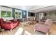 Spacious living room with hardwood floors, comfortable seating, and large windows at 3792 E Briarwood Ave, Centennial, CO 80122