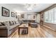 Bright living room with hardwood floors, sectional sofa, and large windows at 3792 E Briarwood Ave, Centennial, CO 80122