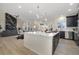 Open concept kitchen boasting a large island and dark cabinetry at 7842 W Oxford Cir, Lakewood, CO 80235