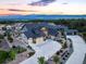 Aerial view of a beautiful home with a three-car garage, lush landscaping, and mountain views at 16486 Florawood Pl, Monument, CO 80132