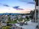 Outdoor patio area with comfortable seating, a fire pit, landscaping, and mountain views at 16486 Florawood Pl, Monument, CO 80132