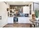 Stylish basement bar with dark tile backsplash, mini fridge, and seating area at 16486 Florawood Pl, Monument, CO 80132