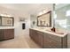 Bathroom with dual sinks, vanity, and ample storage space at 16486 Florawood Pl, Monument, CO 80132