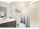 Bright bathroom featuring a single sink vanity and a shower/tub combination with white subway tile at 16486 Florawood Pl, Monument, CO 80132