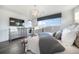 Bright bedroom with a television, large window, stylish light fixture, and elegant decor at 16486 Florawood Pl, Monument, CO 80132