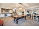 Spacious game room with pool table, bar area, and casual dining space at 16486 Florawood Pl, Monument, CO 80132