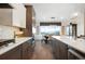 Gourmet kitchen features stainless appliances, stone countertops, island with seating, and views of the outdoors at 16486 Florawood Pl, Monument, CO 80132