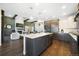 Spacious kitchen with large island, stainless appliances, stone countertops, and an open floorplan at 16486 Florawood Pl, Monument, CO 80132