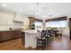 Gourmet kitchen features an island with seating, stainless appliances, stone countertops, and views of the outdoors at 16486 Florawood Pl, Monument, CO 80132