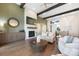 Open-concept living room featuring a fireplace, hardwood floors, and modern decor at 16486 Florawood Pl, Monument, CO 80132