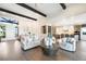 Bright living room featuring wood floors, modern furnishings, and recessed lighting at 16486 Florawood Pl, Monument, CO 80132