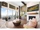 Stylish living room featuring a fireplace, a large sliding glass door, and mountain views at 16486 Florawood Pl, Monument, CO 80132