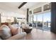 Spacious living room featuring an open floor plan, wood floors, and large windows at 16486 Florawood Pl, Monument, CO 80132