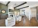 Open-concept living room featuring a fireplace, hardwood floors, and modern decor at 16486 Florawood Pl, Monument, CO 80132