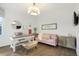 Cozy office space with desk, pink couch, and natural light at 16486 Florawood Pl, Monument, CO 80132