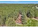Scenic aerial view of the home nestled among lush trees, offering privacy and tranquility at 1332 Meadow Trl, Franktown, CO 80116