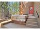 Back deck featuring a covered hot tub, sitting area with chairs, and stairs at 1332 Meadow Trl, Franktown, CO 80116