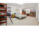 Open basement area features a queen bed, entertainment area, and a bunk bed with ladder at 1332 Meadow Trl, Franktown, CO 80116