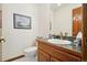 Well lit bathroom featuring a vanity with a solid surface countertop and updated fixtures at 1332 Meadow Trl, Franktown, CO 80116