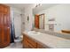 Small updated bathroom with a single vanity, light wood cabinet, and a tiled shower at 1332 Meadow Trl, Franktown, CO 80116