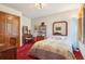 Comfortable bedroom with classic decor, featuring a desk, vanity, a double closet and a warm color carpet at 1332 Meadow Trl, Franktown, CO 80116